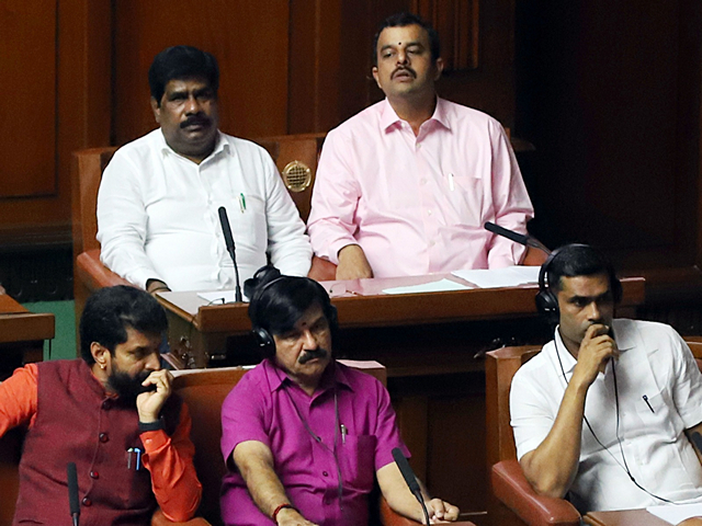 Independent MLA H Nagesh sitting with BJP MLAs during the trust vote. (Photo/ANI) Independent MLA H Nagesh sitting with BJP MLAs during the trust vote. (Photo/ANI)