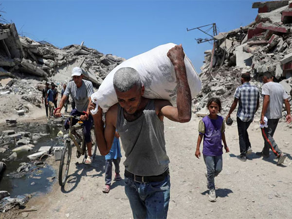A Palestinian carries a bag with aid supplies that entered Gaza through Israel (Image/Reuters) A Palestinian carries a bag with aid supplies that entered Gaza through Israel (Image/Reuters)