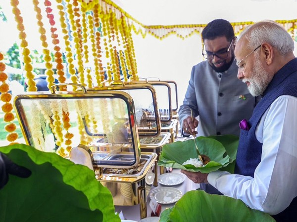 Guyana President Mohamed Irfaan Ali serves meal to PM Modi on a water lily leaf (File photo/ANI) Guyana President Mohamed Irfaan Ali serves meal to PM Modi on a water lily leaf (File photo/ANI)