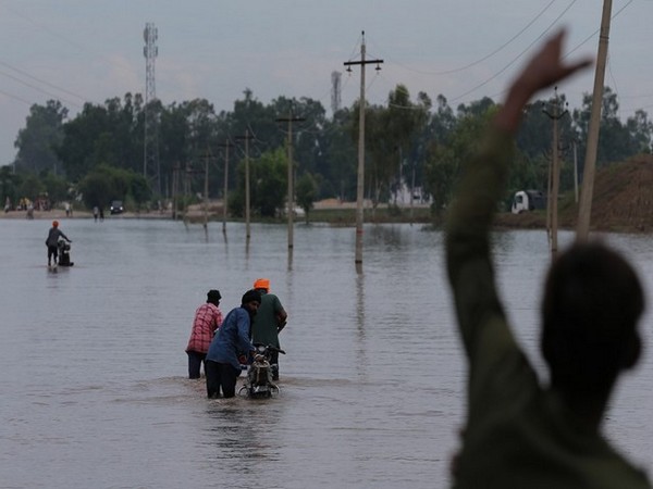 Commuters wade their way through waterlogged roads in the flood-affected area in Punjab (File Photo/ANI) Commuters wade their way through waterlogged roads in the flood-affected area in Punjab (File Photo/ANI)