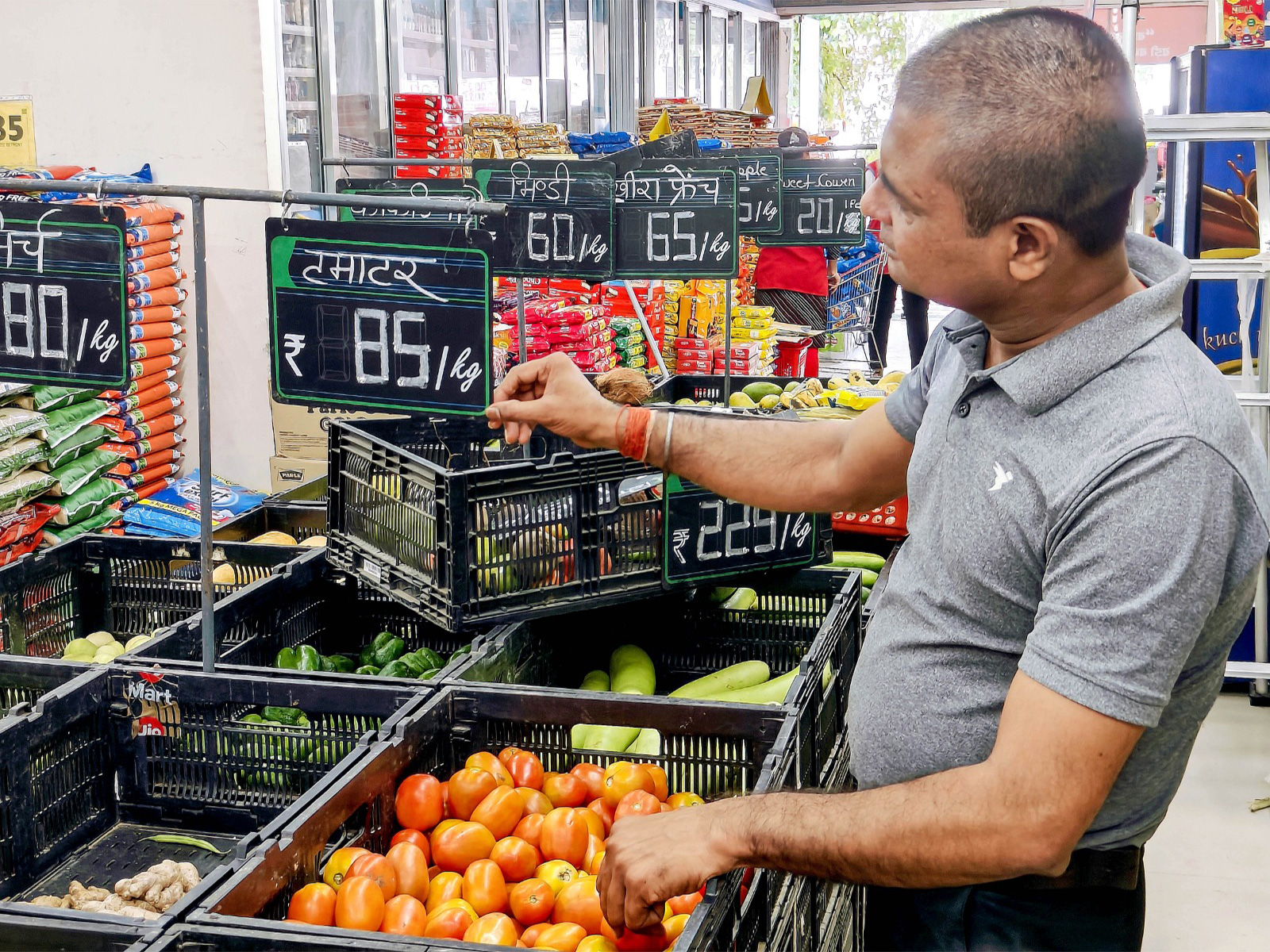 A salesman updates the price tag (File Photo/ANI) A salesman updates the price tag (File Photo/ANI)