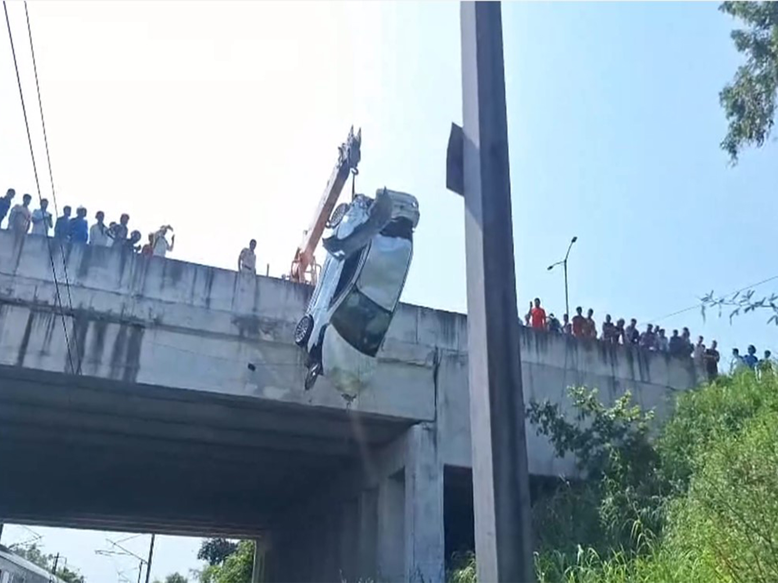 Car falls from Mukarba Chowk flyover onto railway tracks (Photo/ANI) Car falls from Mukarba Chowk flyover onto railway tracks (Photo/ANI)