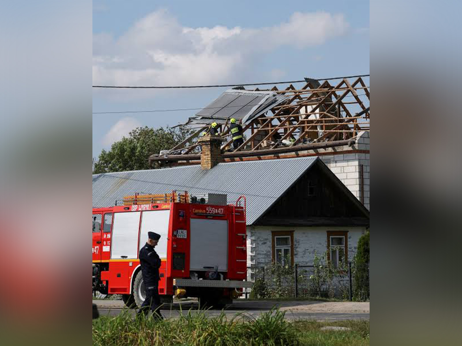 A police officer stands as firefighters work on the destroyed roof of a house in Wyryki, Lublin Voivodeship, Poland (File Photo/Reuters) A police officer stands as firefighters work on the destroyed roof of a house in Wyryki, Lublin Voivodeship, Poland (File Photo/Reuters)
