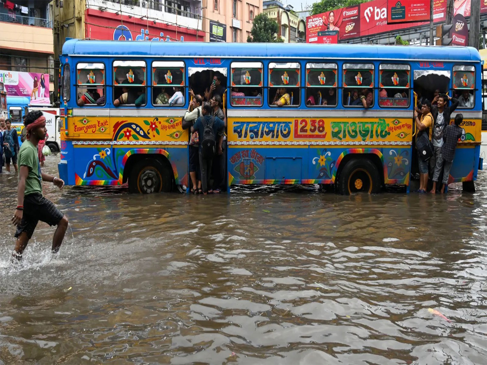 A passenger bus navigating through a waterlogged road (Pic/Shashi Tharoor/ X) A passenger bus navigating through a waterlogged road (Pic/Shashi Tharoor/ X)