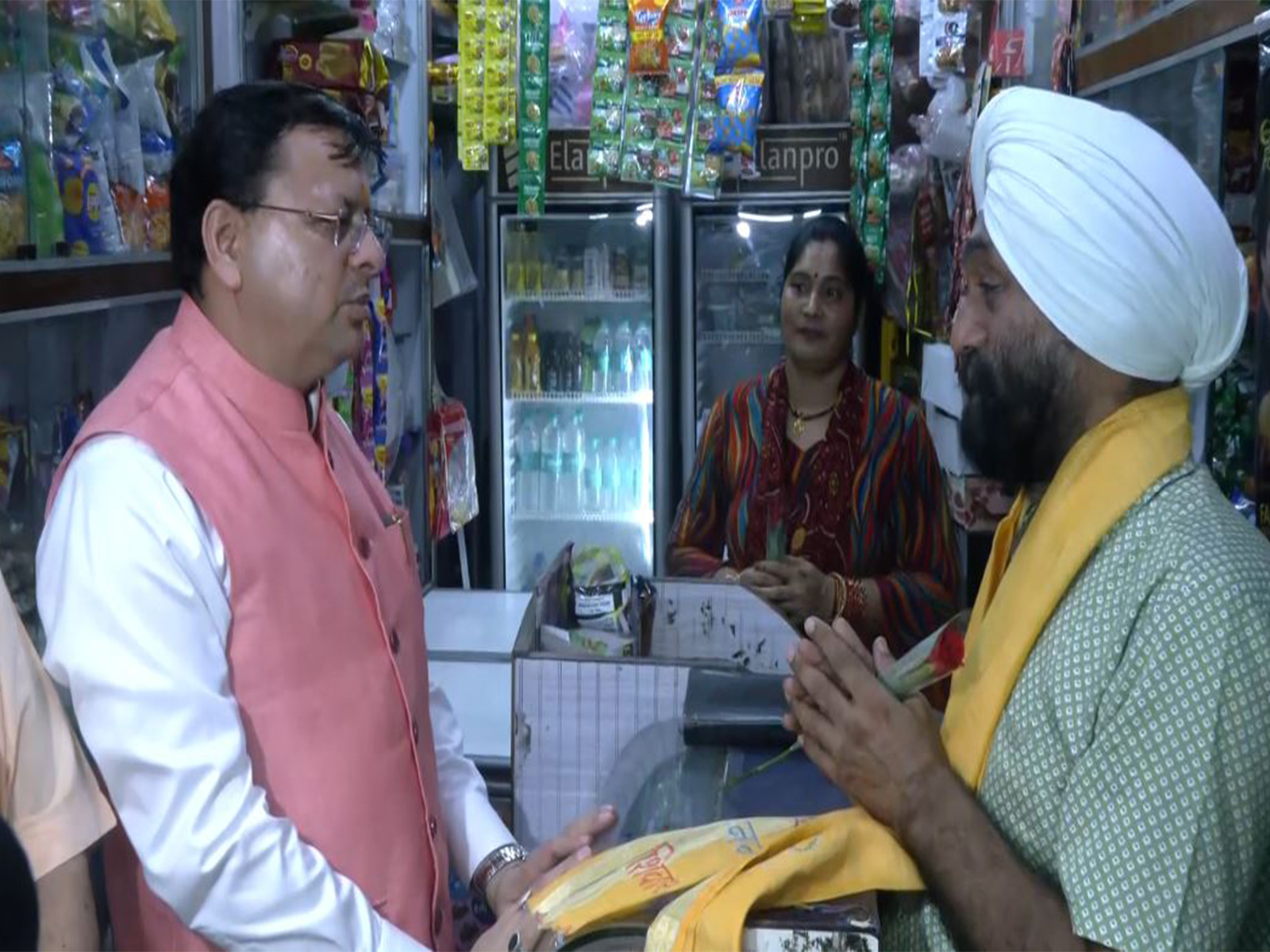 Uttarakhand CM Dhami speaking to a trader. (Photo/ANI) Uttarakhand CM Dhami speaking to a trader. (Photo/ANI)