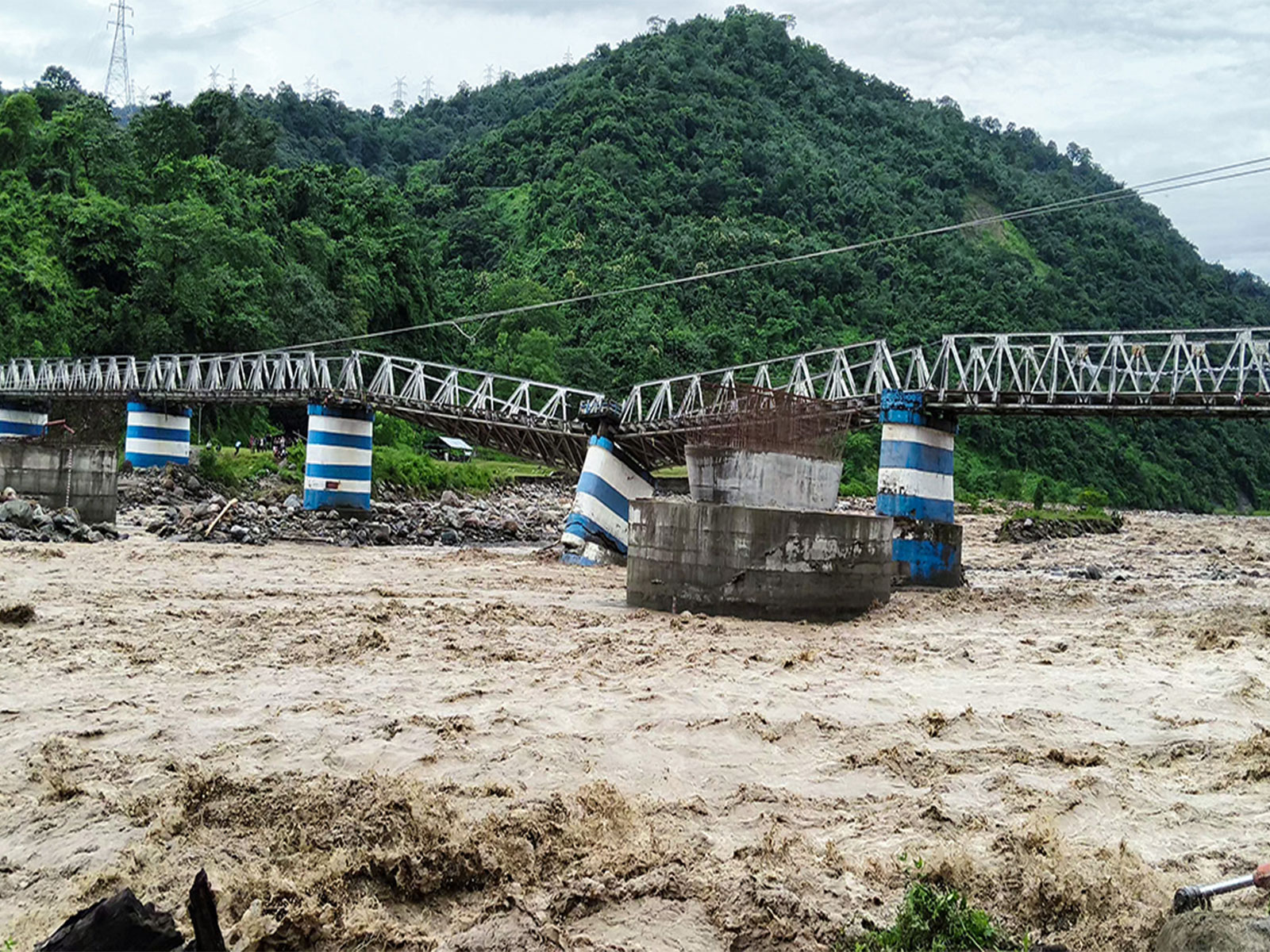 A portion of the Dudhia iron bridge collapsed due to heavy rain, in Darjeeling on October 5, 2025 (Photo/ANI)