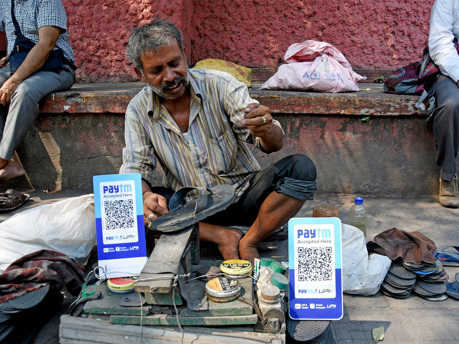 A cobbler uses Paytm as a mode of payment (File Photo/ANI) A cobbler uses Paytm as a mode of payment (File Photo/ANI)