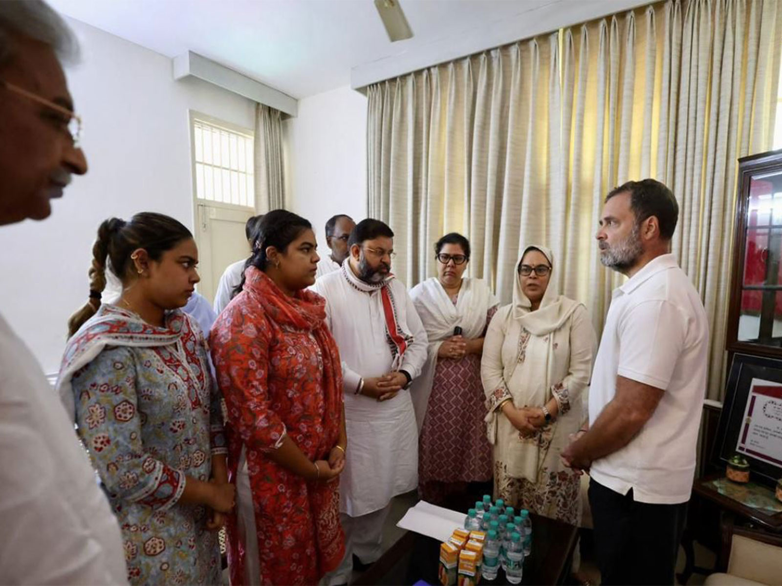 Congress MP Rahul Gandhi with family of IPS Puran Kumar (Photo: ANI) Congress MP Rahul Gandhi with family of IPS Puran Kumar (Photo: ANI)