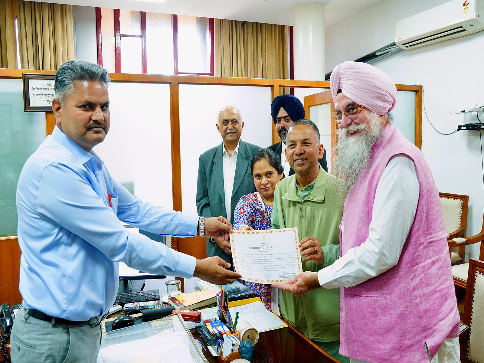 Punjab Vidhan Sabha Secretary Ram Lok Khatana hands over certificate of Election to Rajya Sabha candidate Rajinder Gupta (Source-Information and Public Relations Department, Punjab) Punjab Vidhan Sabha Secretary Ram Lok Khatana hands over certificate of Election to Rajya Sabha candidate Rajinder Gupta (Source-Information and Public Relations Department, Punjab)