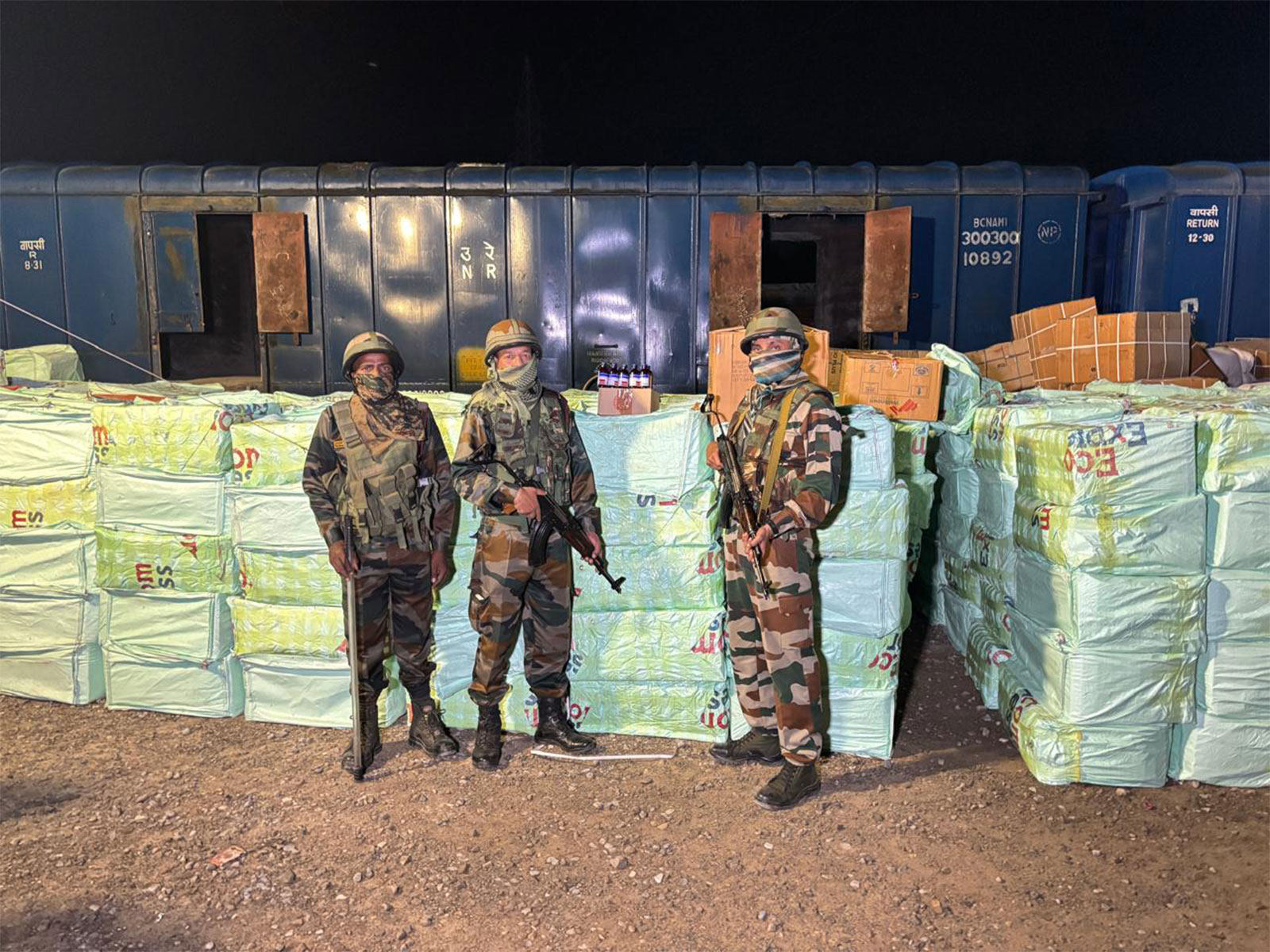 Assam Rifles with seized quantity of codeine-based syrup. (Photo/ANI) Assam Rifles with seized quantity of codeine-based syrup. (Photo/ANI)