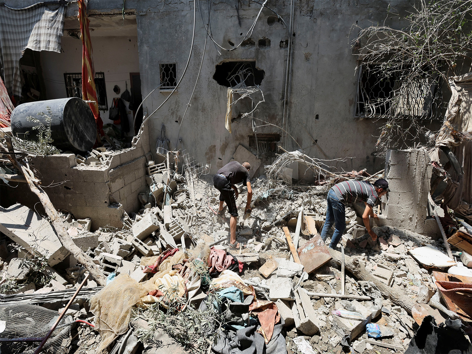 Palestinians inspect a house damaged in Israeli air strike. (File Photo/Reuters) Palestinians inspect a house damaged in Israeli air strike. (File Photo/Reuters)