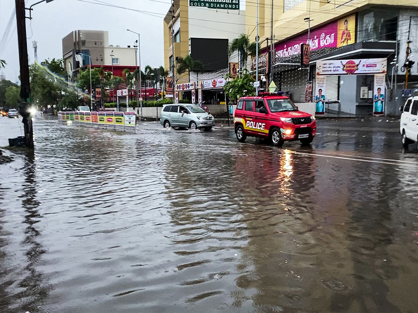 Vehicles wade through a water-logged street after heavy rainfall, in Thoothukudi on Tuesday (Photo/ANI) Vehicles wade through a water-logged street after heavy rainfall, in Thoothukudi on Tuesday (Photo/ANI)