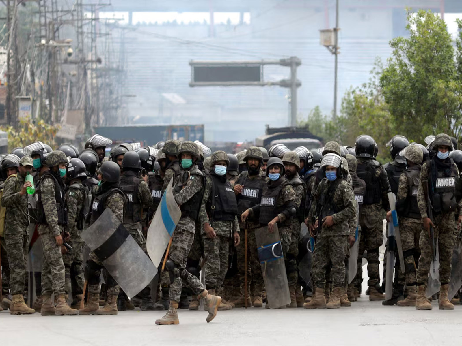Security personnel stand guard during a TLP protest in Punjab as authorities reopen major roads amid ongoing demonstrations toward Islamabad. (File Photo/Reuters) Security personnel stand guard during a TLP protest in Punjab as authorities reopen major roads amid ongoing demonstrations toward Islamabad. (File Photo/Reuters)