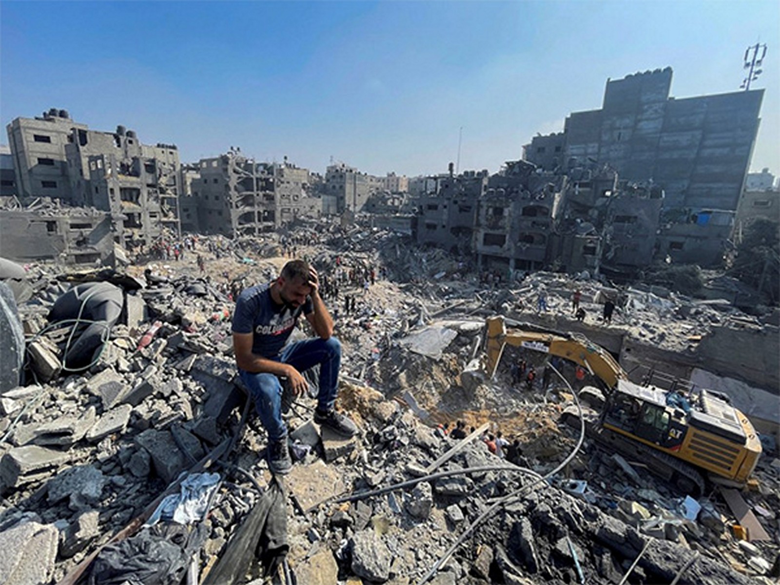 A man sits amid the rubble of destroyed buildings in Gaza following Israeli airstrikes (File Photo/ Reuters) A man sits amid the rubble of destroyed buildings in Gaza following Israeli airstrikes (File Photo/ Reuters)