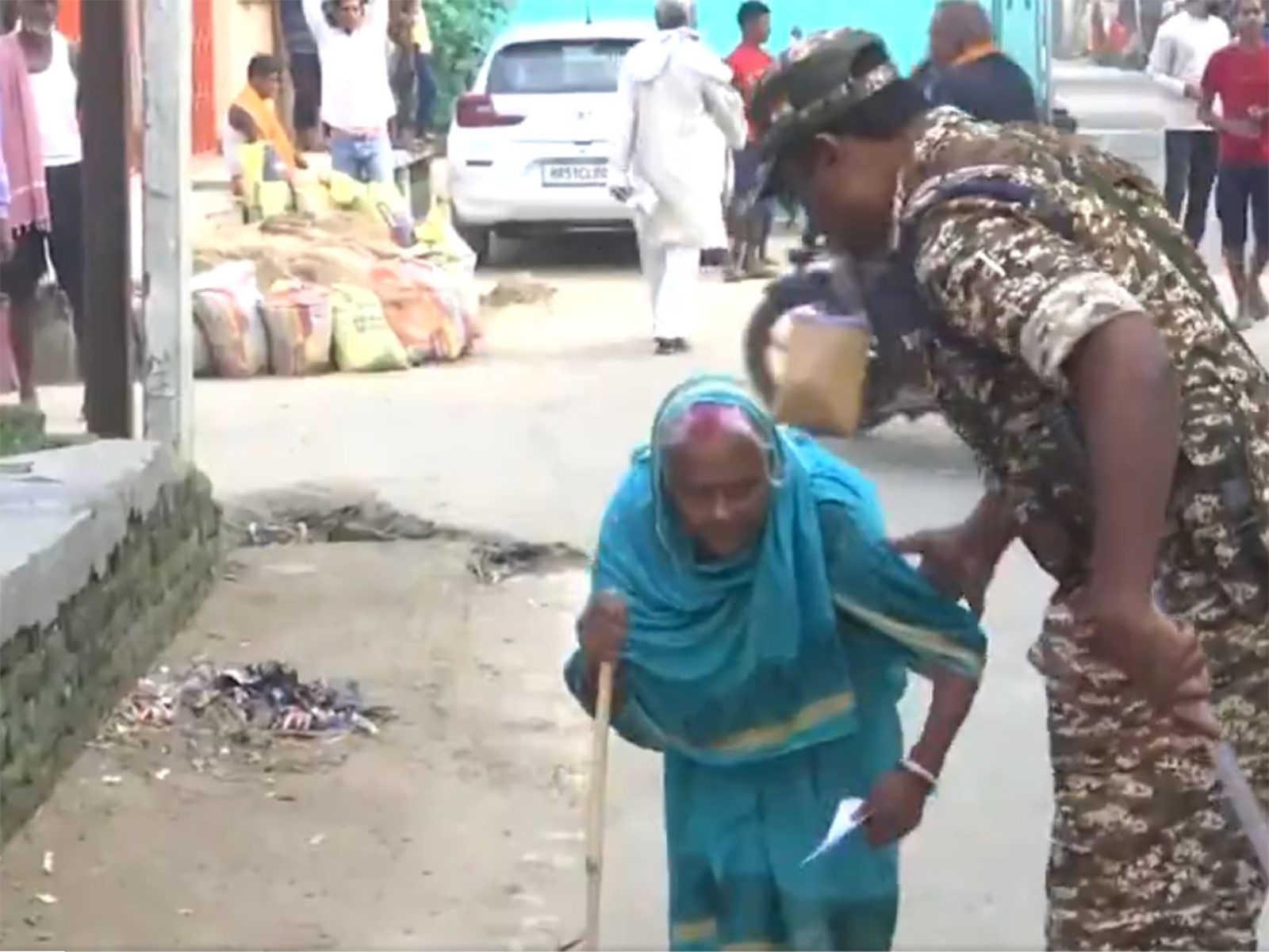 Elderly woman helped by security personnel (Photo: ANI) Elderly woman helped by security personnel (Photo: ANI)