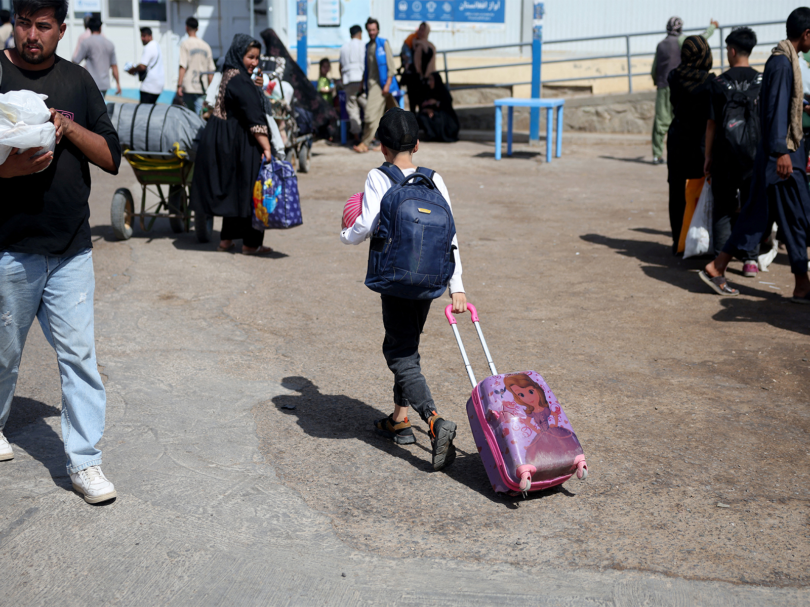 An Afghan boy deported from Iran pulls a rolling suitcase at a camp for returning migrants near the Islam Qala border crossing (Photo/Reuters) An Afghan boy deported from Iran pulls a rolling suitcase at a camp for returning migrants near the Islam Qala border crossing (Photo/Reuters)