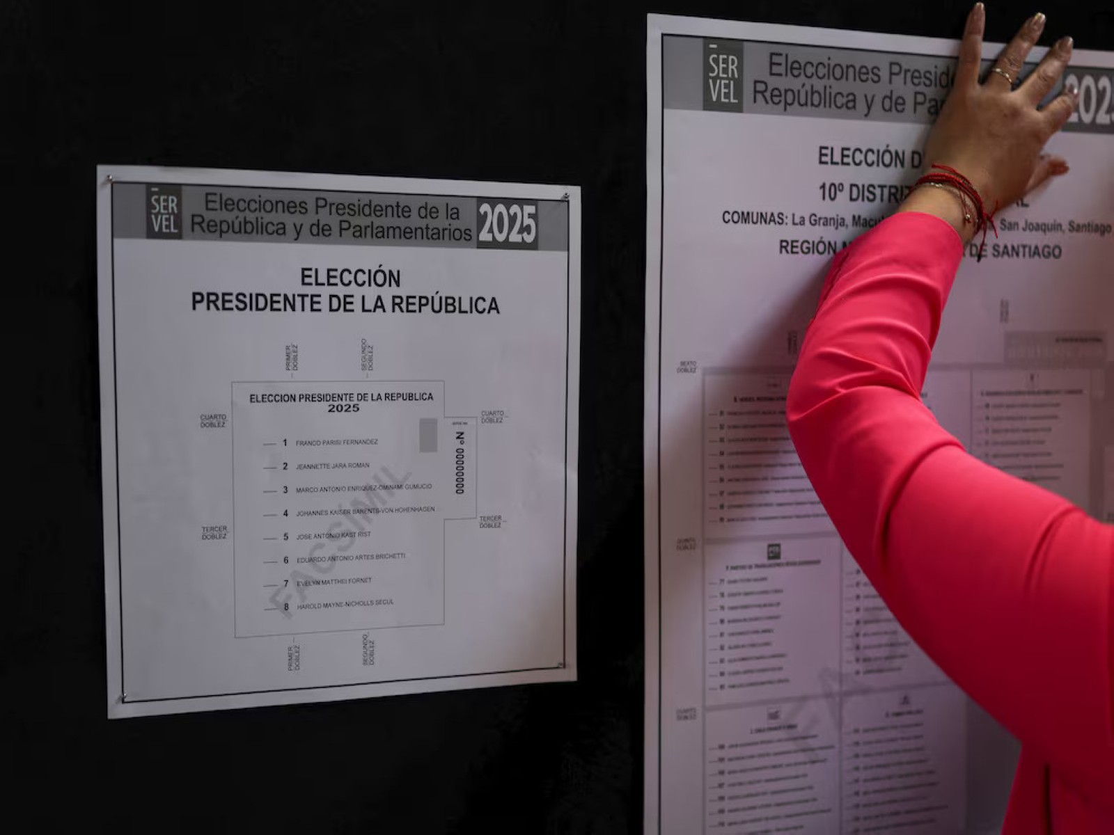 A worker posts election information at a polling station in Santiago, Chile. (File Photo/Reuters) A worker posts election information at a polling station in Santiago, Chile. (File Photo/Reuters)