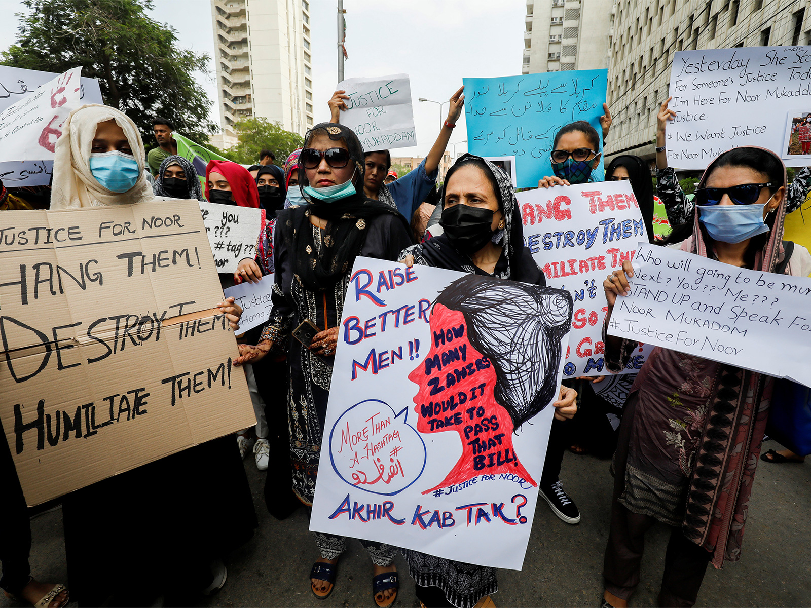 People carry signs to condemn the violence against women and girls during a protest in Karachi (File Photo/Reuters)