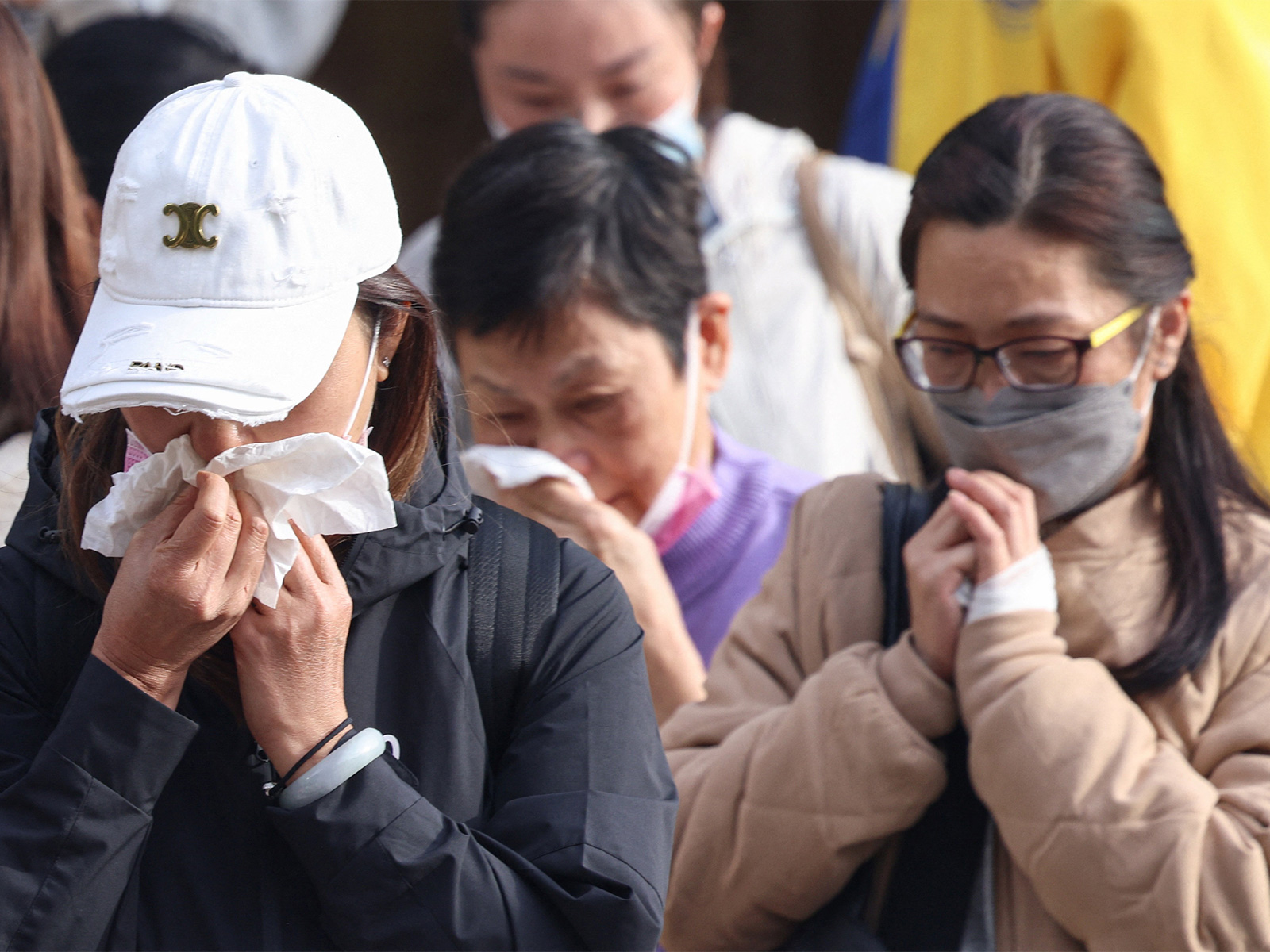 Relatives react after identifying family members from photos at Kwong Fuk Community Hall following the Wang Fuk Court housing estate fire, in Tai Po, Hong Kong (Photo/Reuters) Relatives react after identifying family members from photos at Kwong Fuk Community Hall following the Wang Fuk Court housing estate fire, in Tai Po, Hong Kong (Photo/Reuters)