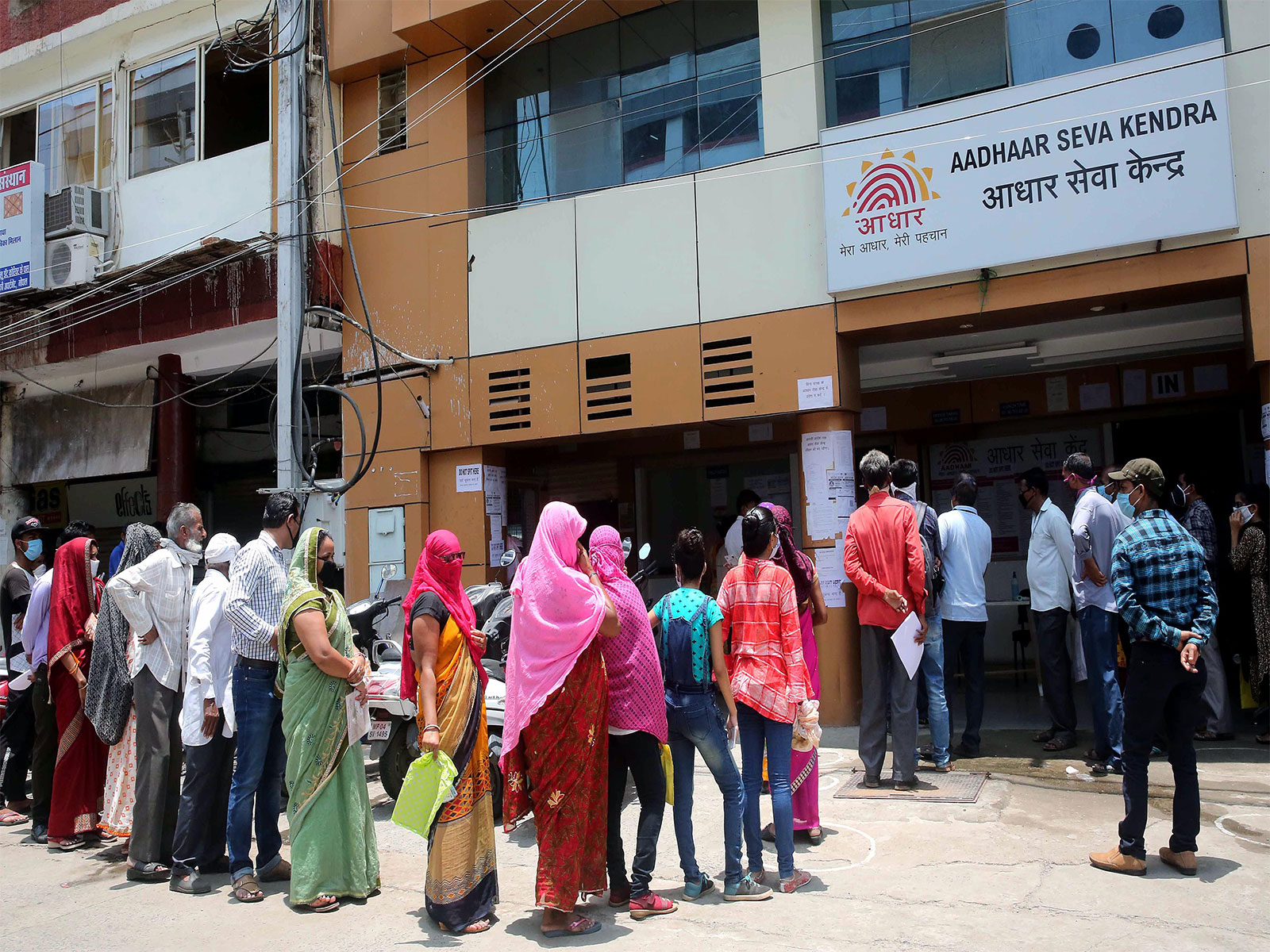 People queue outside an Aadhaar service centre (Photo/ANI) People queue outside an Aadhaar service centre (Photo/ANI)