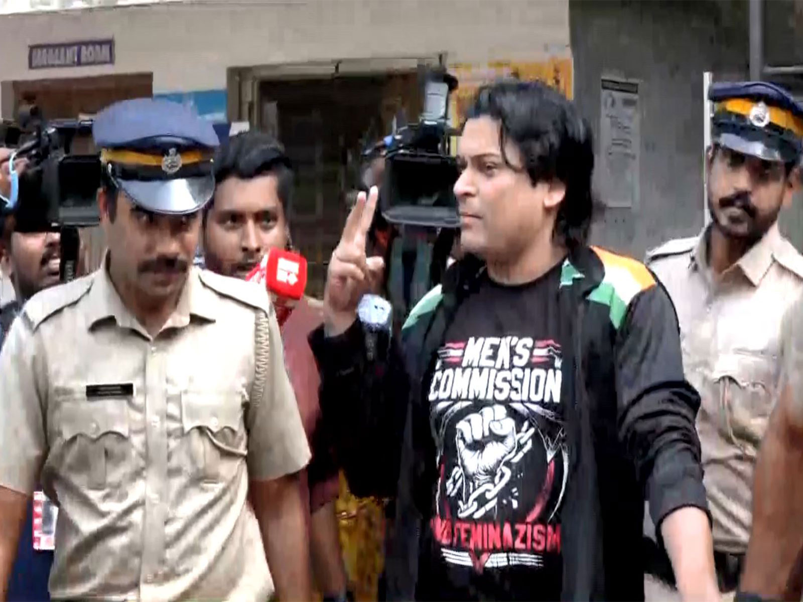 Activist Rahul Easwar speaks to reporters while being taken for a medical examination in Thiruvananthapuram. (Photo/ANI)