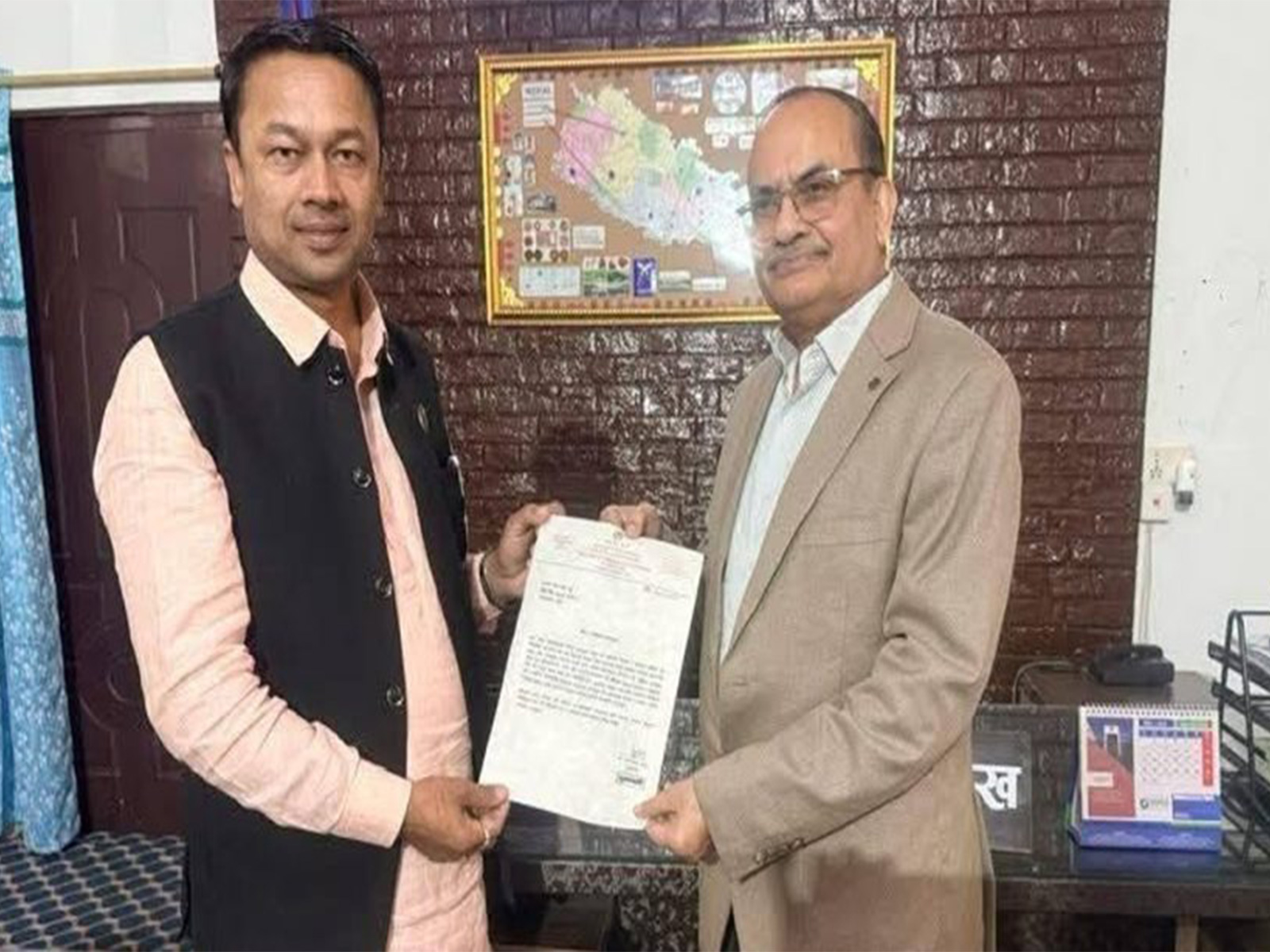 Chief Minister of Nepal’s Madhesh Province, Saroj Kumar Yadav (left), hands over his resignation letter to the province head after announcing his resignation in Janakpur on December 3, 2025. (Image Source: Office of the Chief Minister, Madhesh Province)