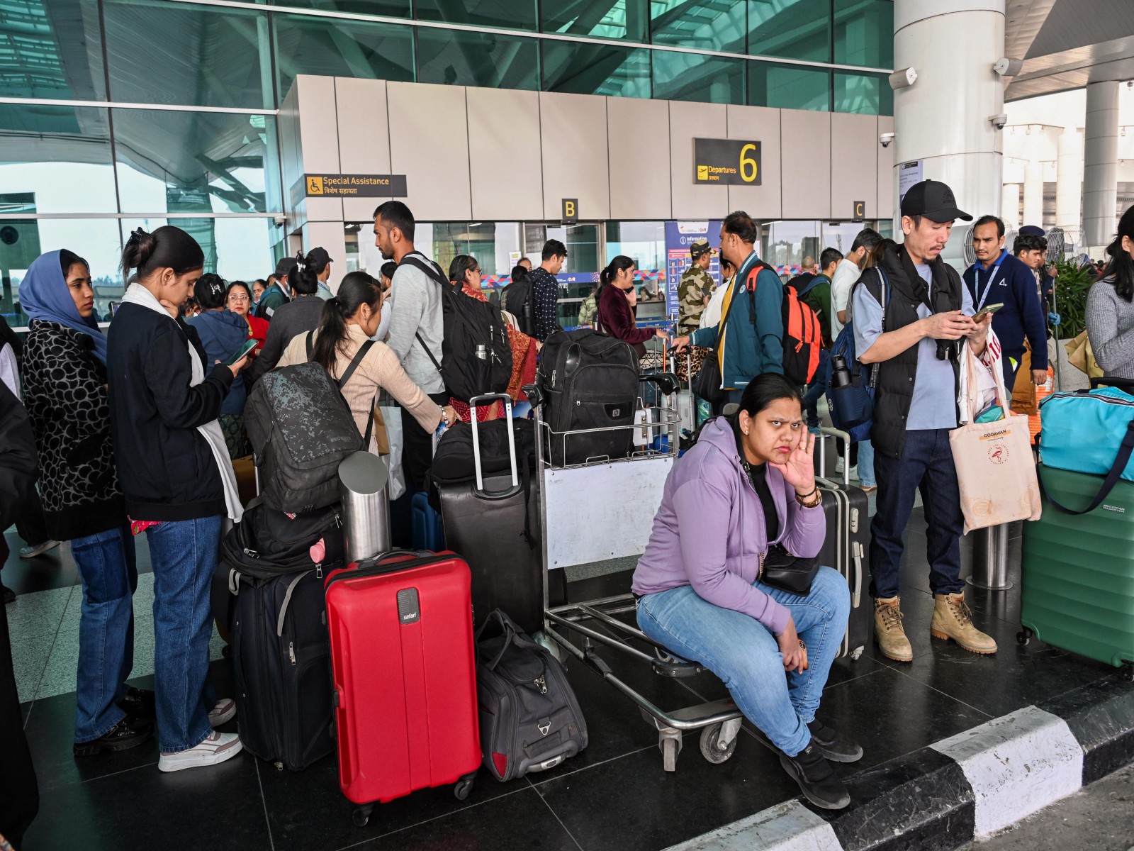 Flight passengers wait with their baggage as many IndiGo flight services stand cancelled in Delhi Airport (File Photo/ANI) Flight passengers wait with their baggage as many IndiGo flight services stand cancelled in Delhi Airport (File Photo/ANI)
