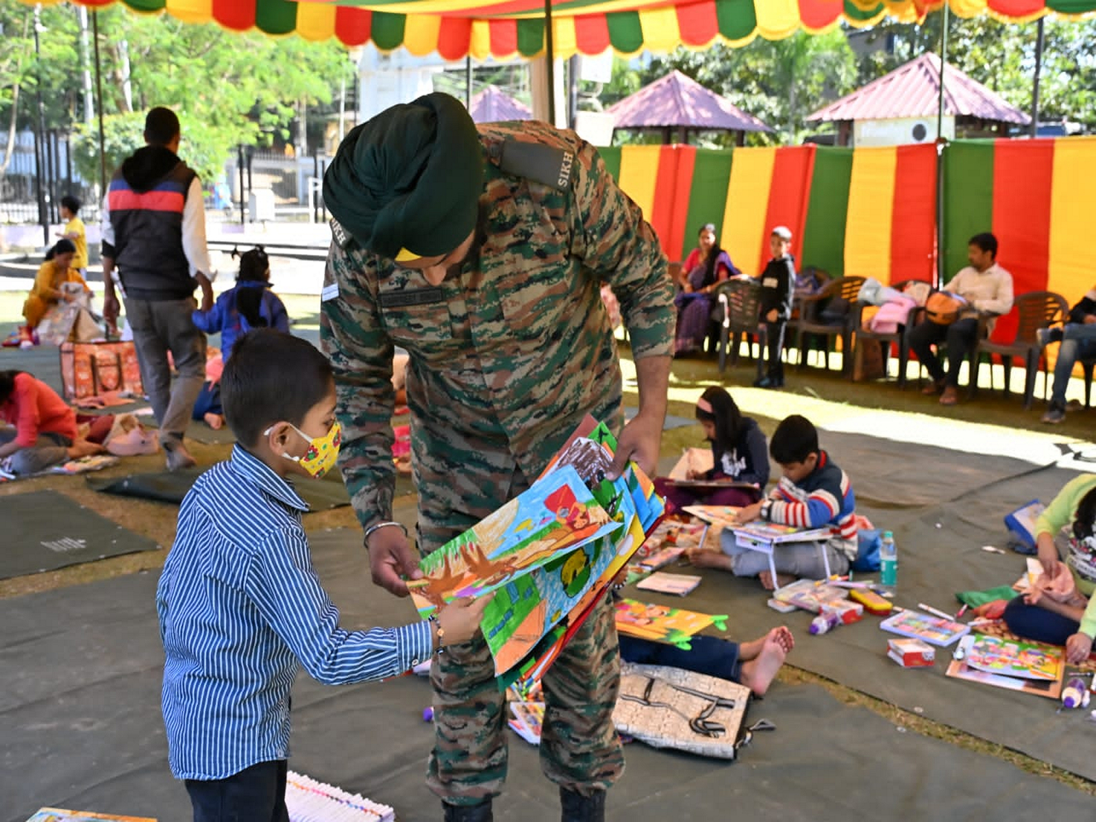 Indian army personnel with a kid during Vijay Diwas celebrations in Agartala on Sunday. (Photo/Army HQ, Shalbagan, Agartala) Indian army personnel with a kid during Vijay Diwas celebrations in Agartala on Sunday. (Photo/Army HQ, Shalbagan, Agartala)