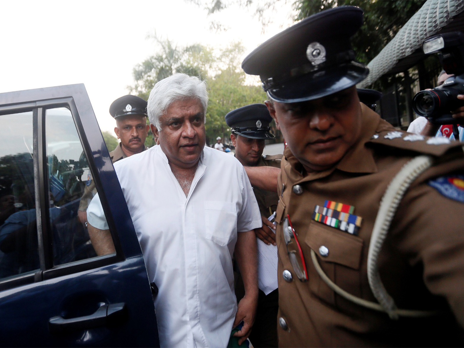 Police escort deposed minister Arjuna Ranatunga to a court, in Colombo  (File Photo/ Reuters)