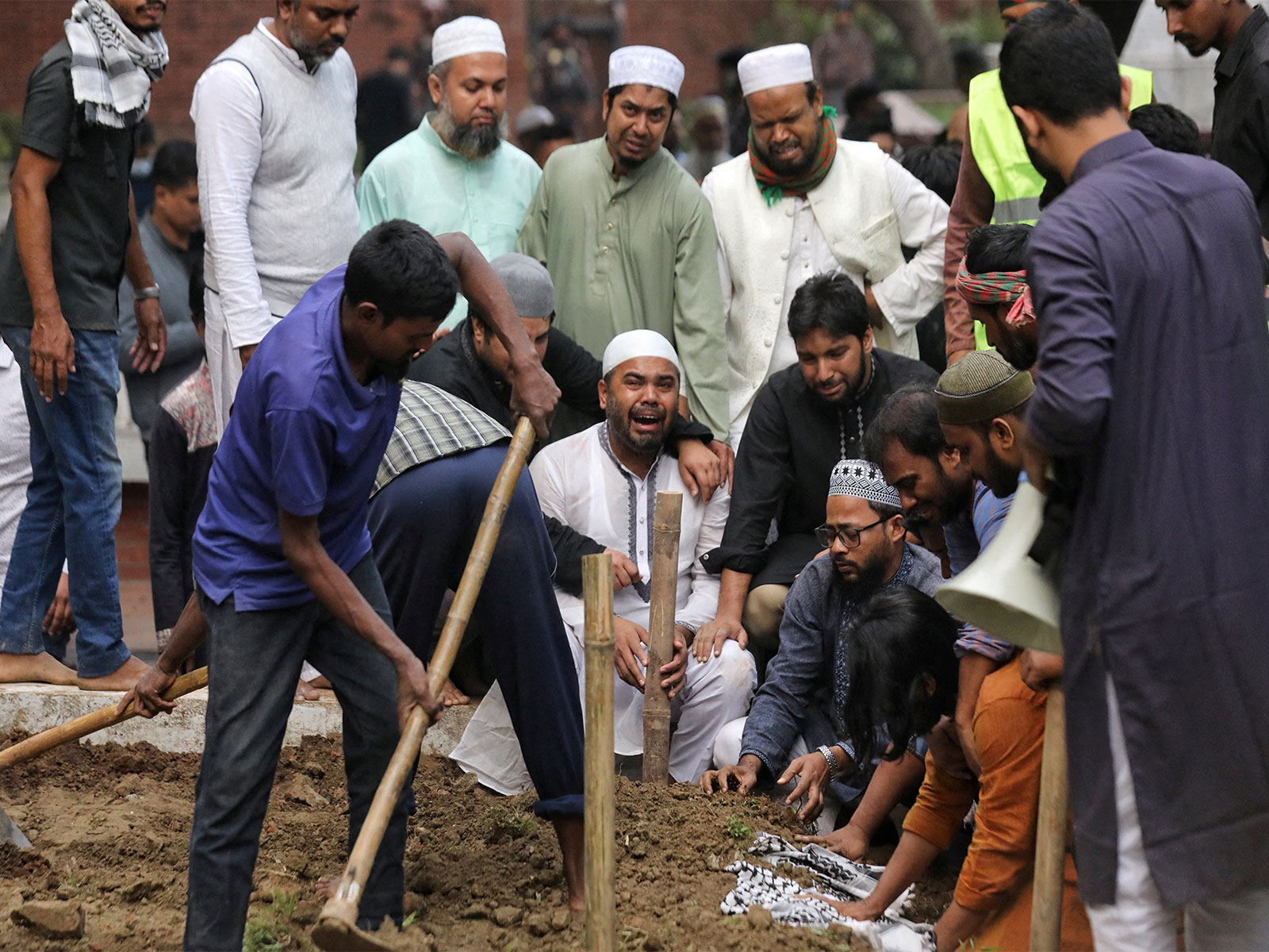 Omar Faruk, brother of Sharif Osman Hadi, a student leader who died after being shot in the head, mourns during the burial, in Dhaka (Photo/Reuters) Omar Faruk, brother of Sharif Osman Hadi, a student leader who died after being shot in the head, mourns during the burial, in Dhaka (Photo/Reuters)