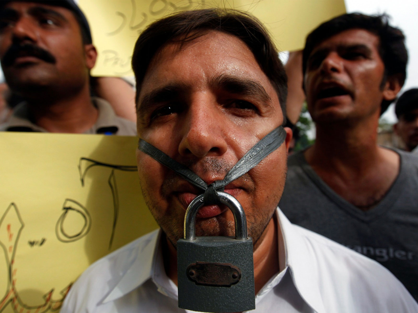 A journalist hangs a lock across his lips during a protest against the freedom of press in Karachi  (File Photo/ Reuters)