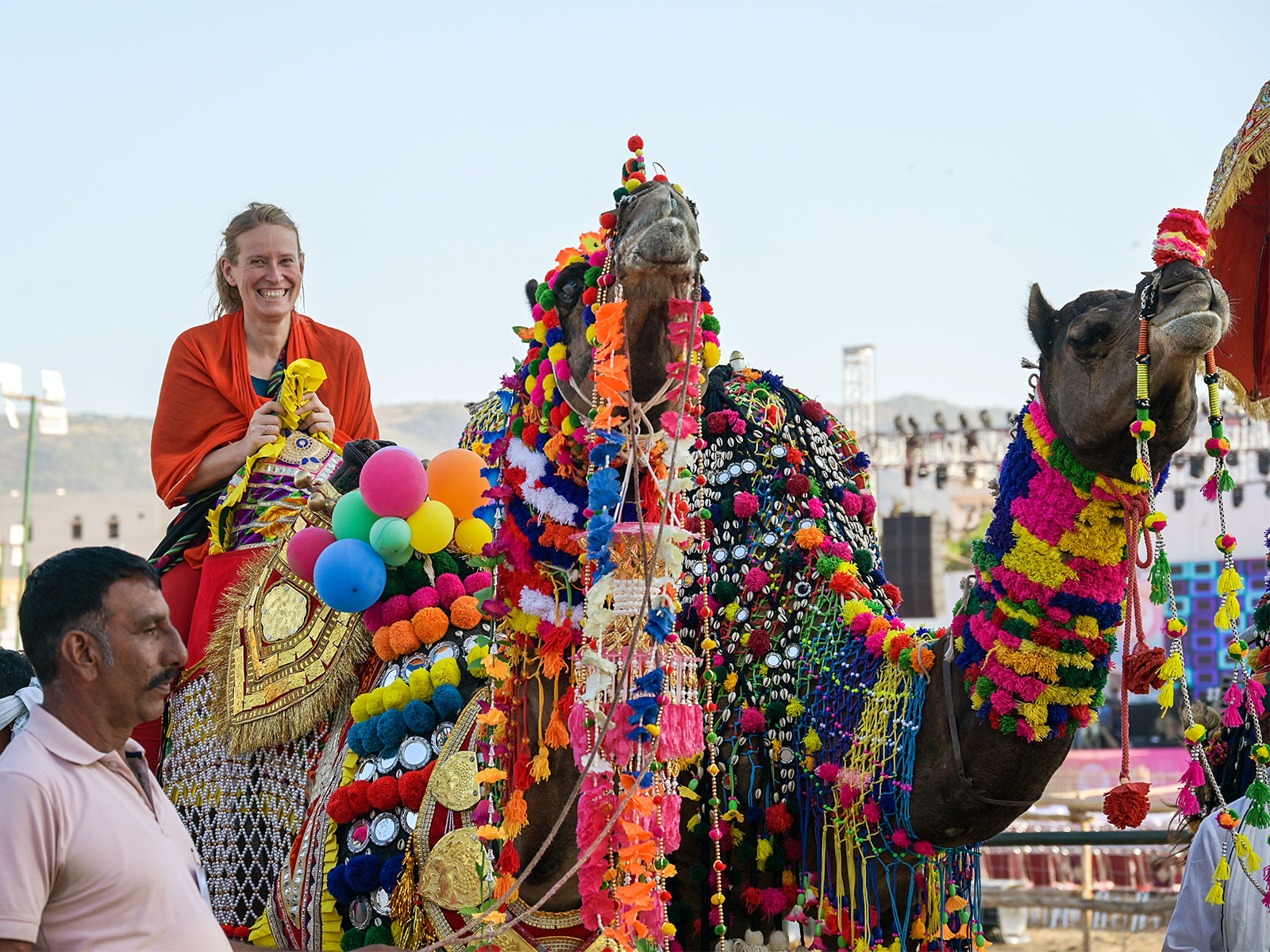 A foreign tourist takes a ride on a decorated camel (File Photo/ANI)