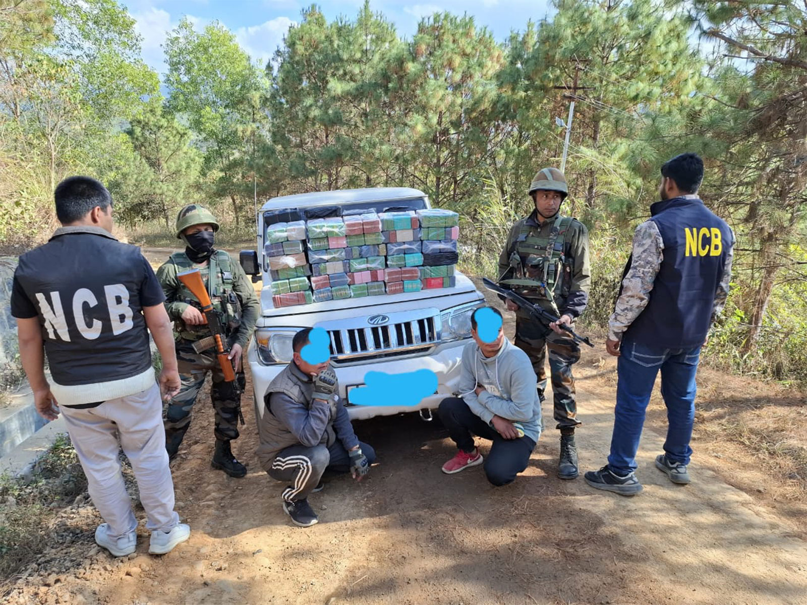Narcotics Control Bureau (NCB) officials with arrested drug-traffickers in Imphal. (Photo/ANI)
