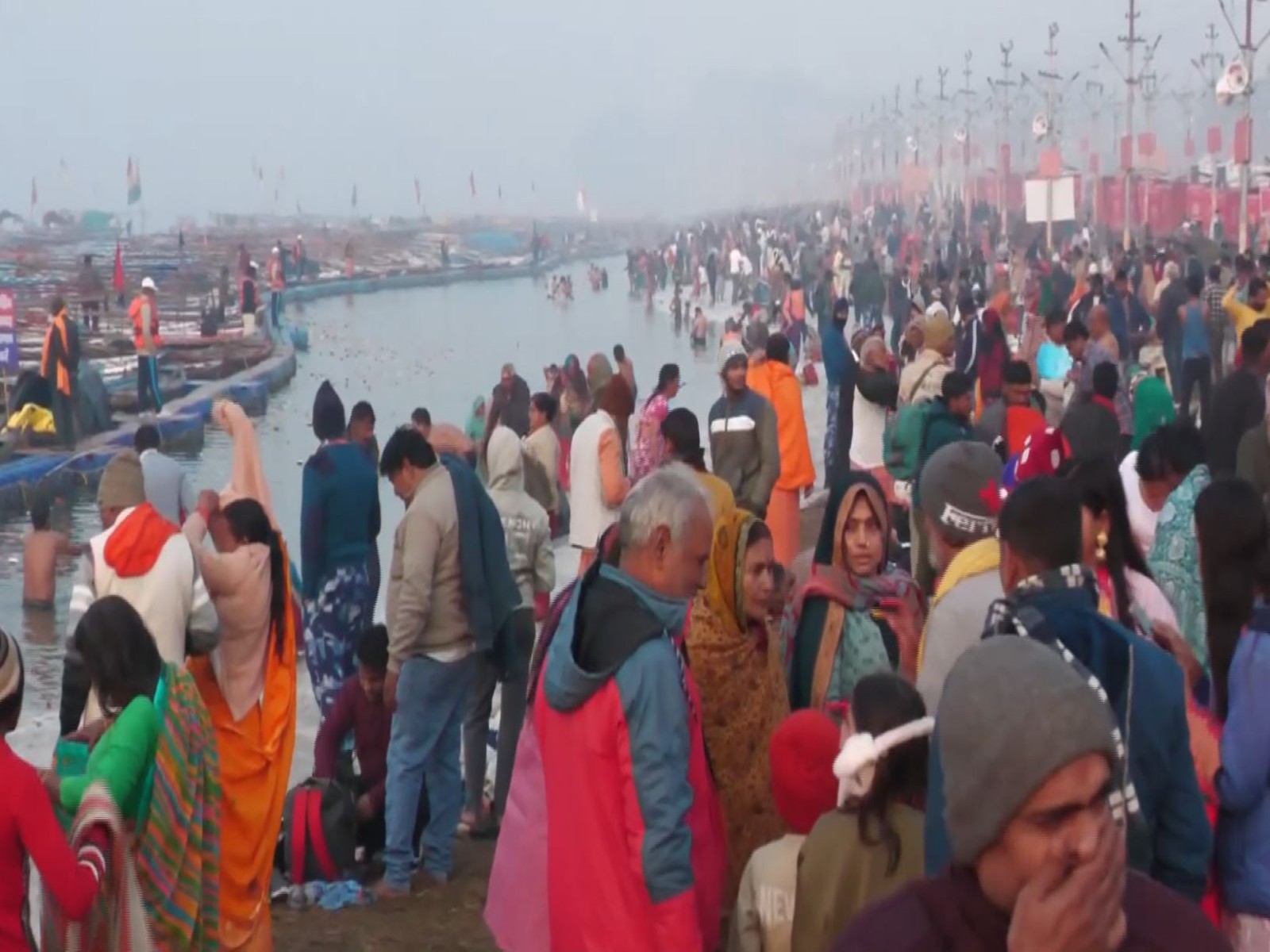 Large number of devotees taking a holy dip during the ongoing Magh Mela despite extreme cold conditions (Photo/ANI)