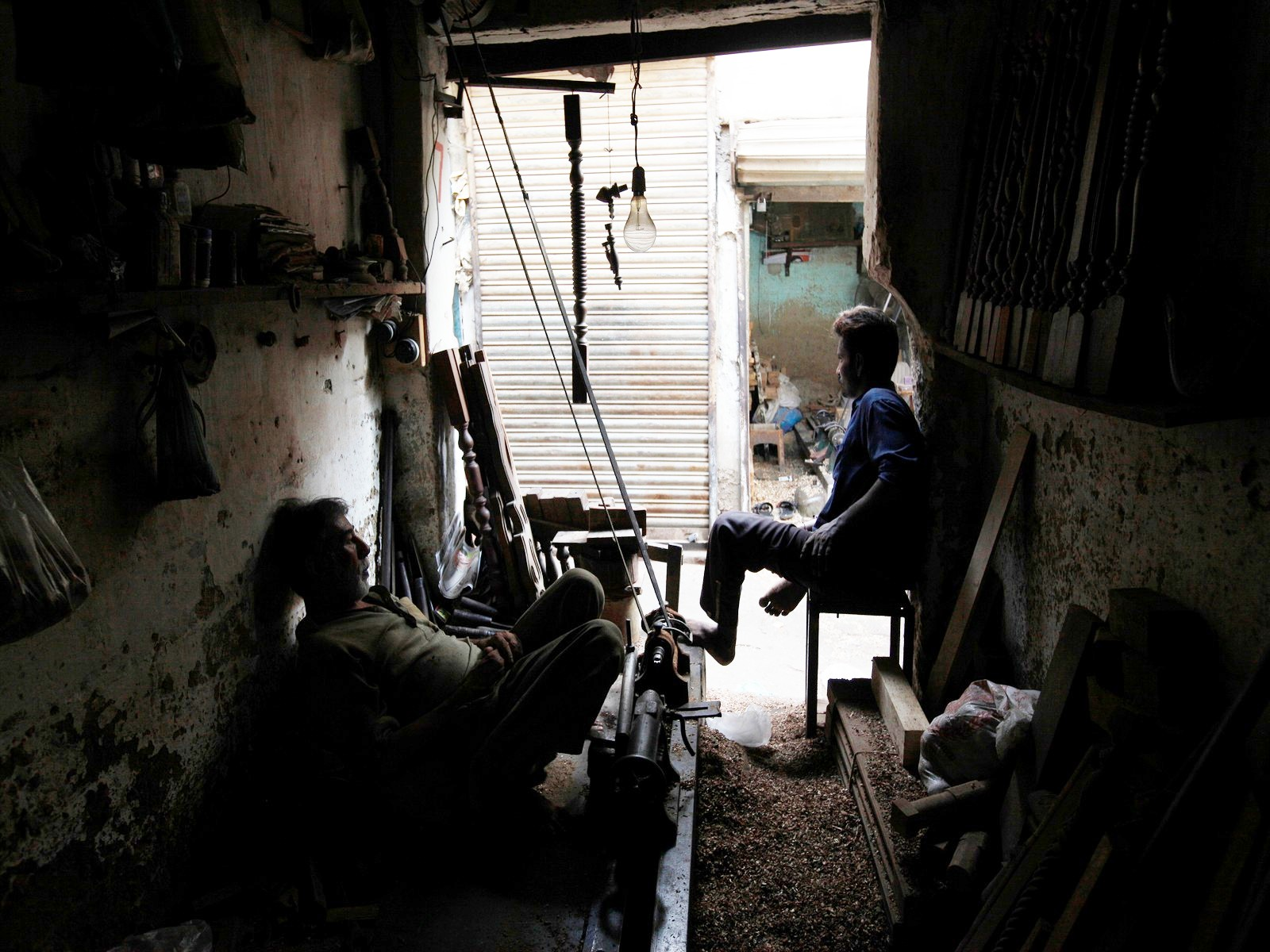 Shopworkers sitting in dark in Pakistan (File Photo/ Reuters)
