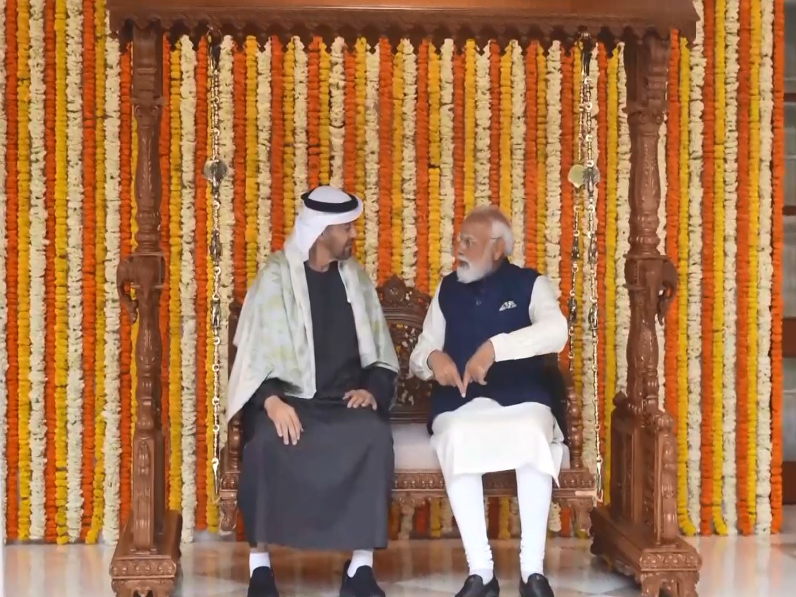 Prime Minister Narendra Modi and UAE President Sheikh Mohamed bin Zayed Al Nahyan sit on the Royal carved wooden Jhula gifted as part of traditional Indian presents during the UAE leader’s official visit, at Lok Kalyan Marg in New Delhi. (Photo/ANI)