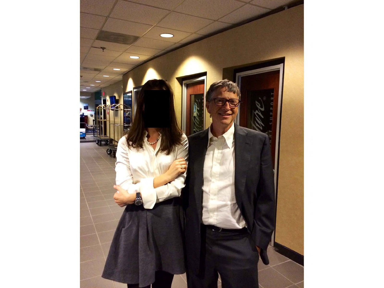 Bill Gates with woman whose identity is obscured, as appeared in DOJ-released files (Photo/Reuters)