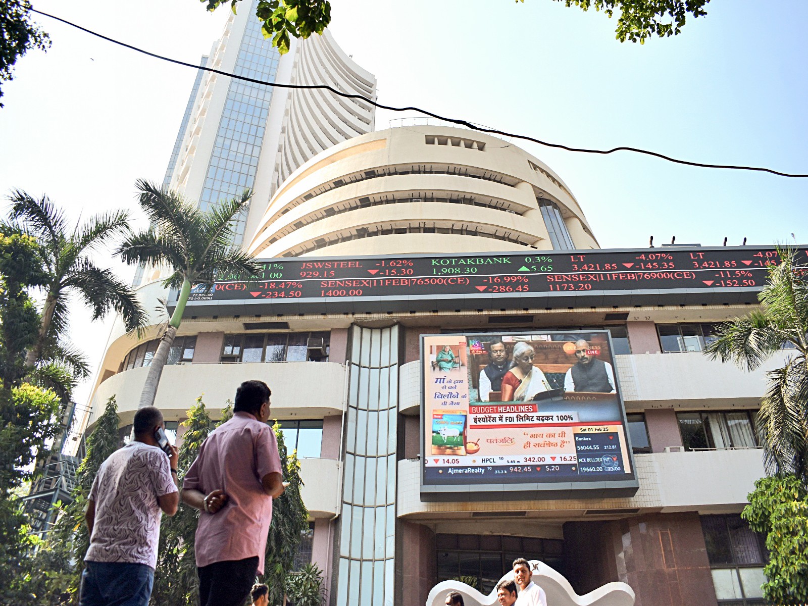 People watch the live telecast of Union Budget on a display screen outside BSE (File Photo/ANI)
