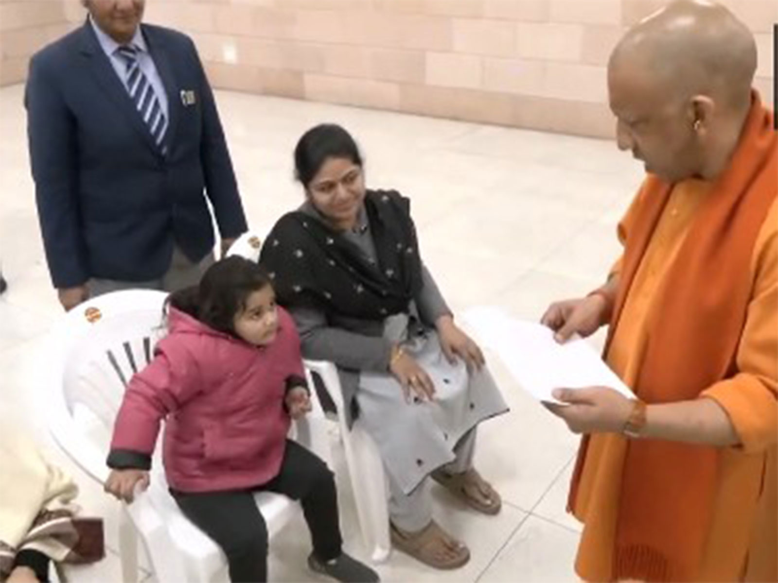 UP CM Yogi Adityanath interacting with a child during 'Janta Darshan' (Photo/ANI)
