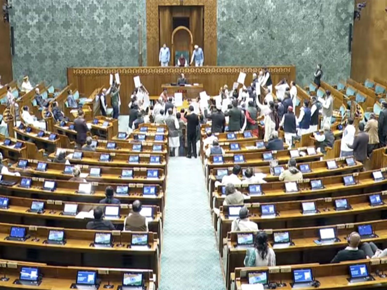 Opposition MPs flash placards and shout slogans against the Central govt in the Lok Sabha (Photo/Youtube/SansadTV)