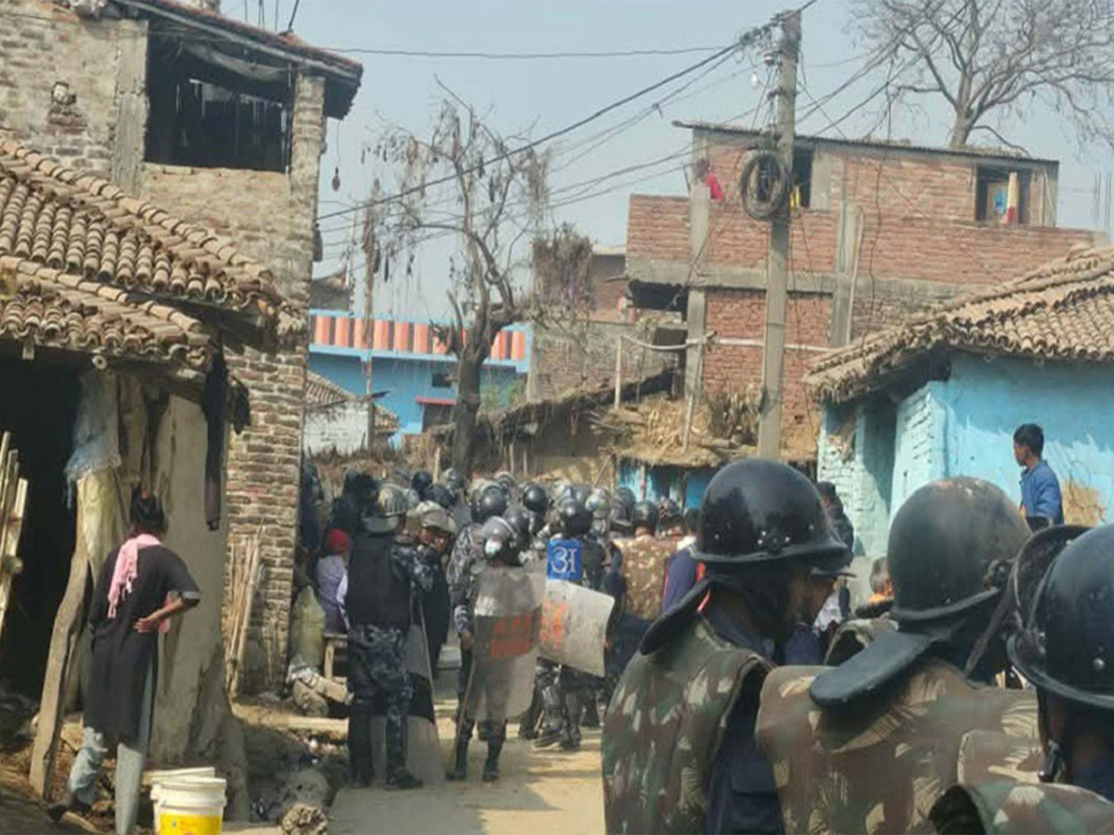 Security personnel move through a locality in Gaur Municipality, Rautahat district, after an indefinite curfew was imposed following communal clashes. (Photo/ANI)