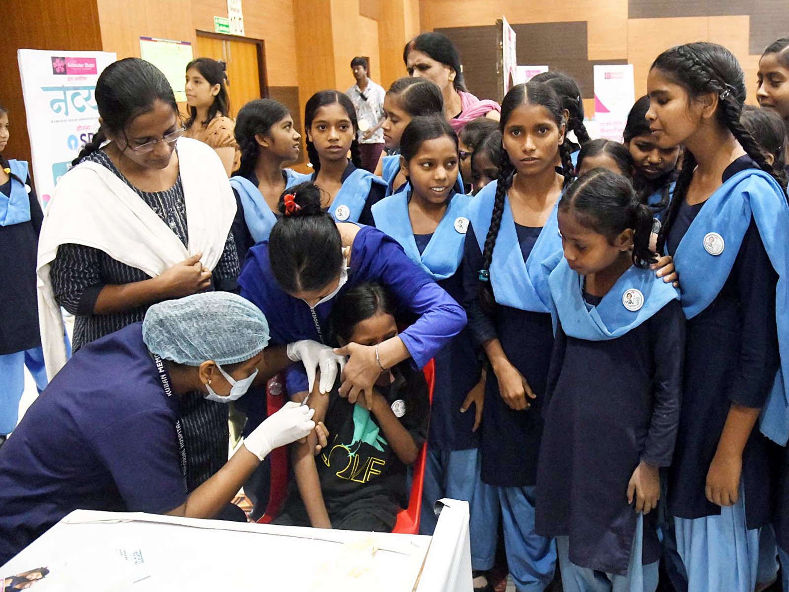 A health worker inoculates the HPV vaccines to a school girl during a free HPV vaccination camp (Photo/ANI)