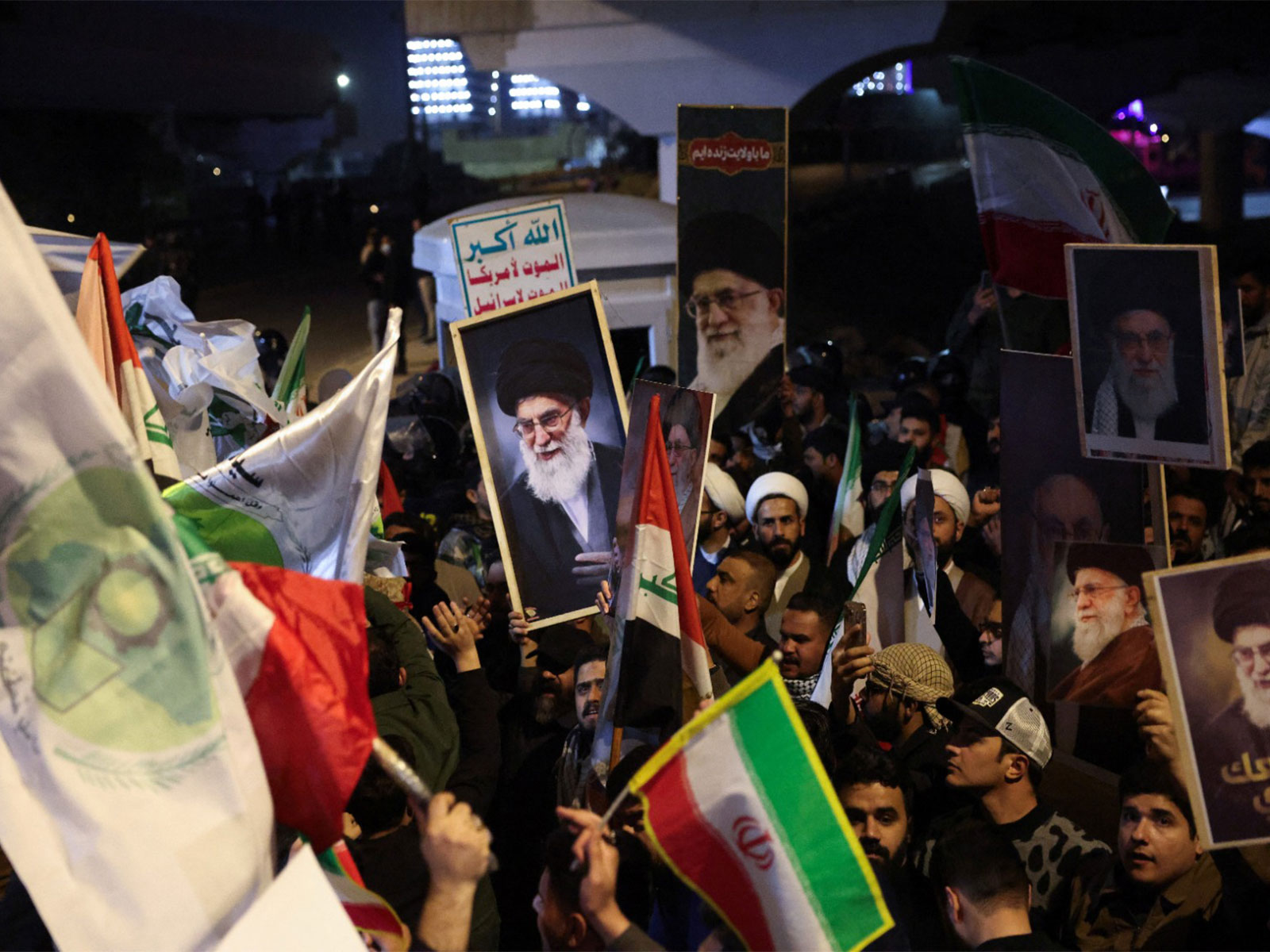Supporters of Iraqi Shia armed groups display portraits of Iran's Supreme Leader Ayatollah Ali Khamenei as they gather near the entrance of Baghdad's Green Zone to show support for Iran on Feb 28, 2026  (Photo/Reuters)