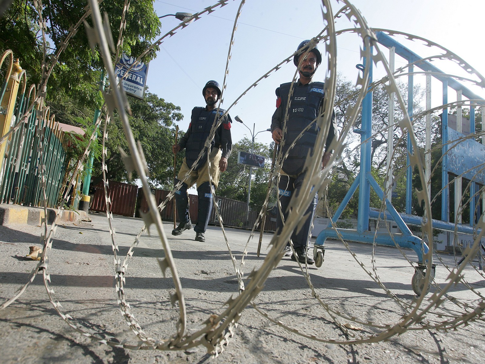 Pakistani policemen stand guard at a closed street leading towards the U.S. consulate in Karachi (File Photo/Reuters)
