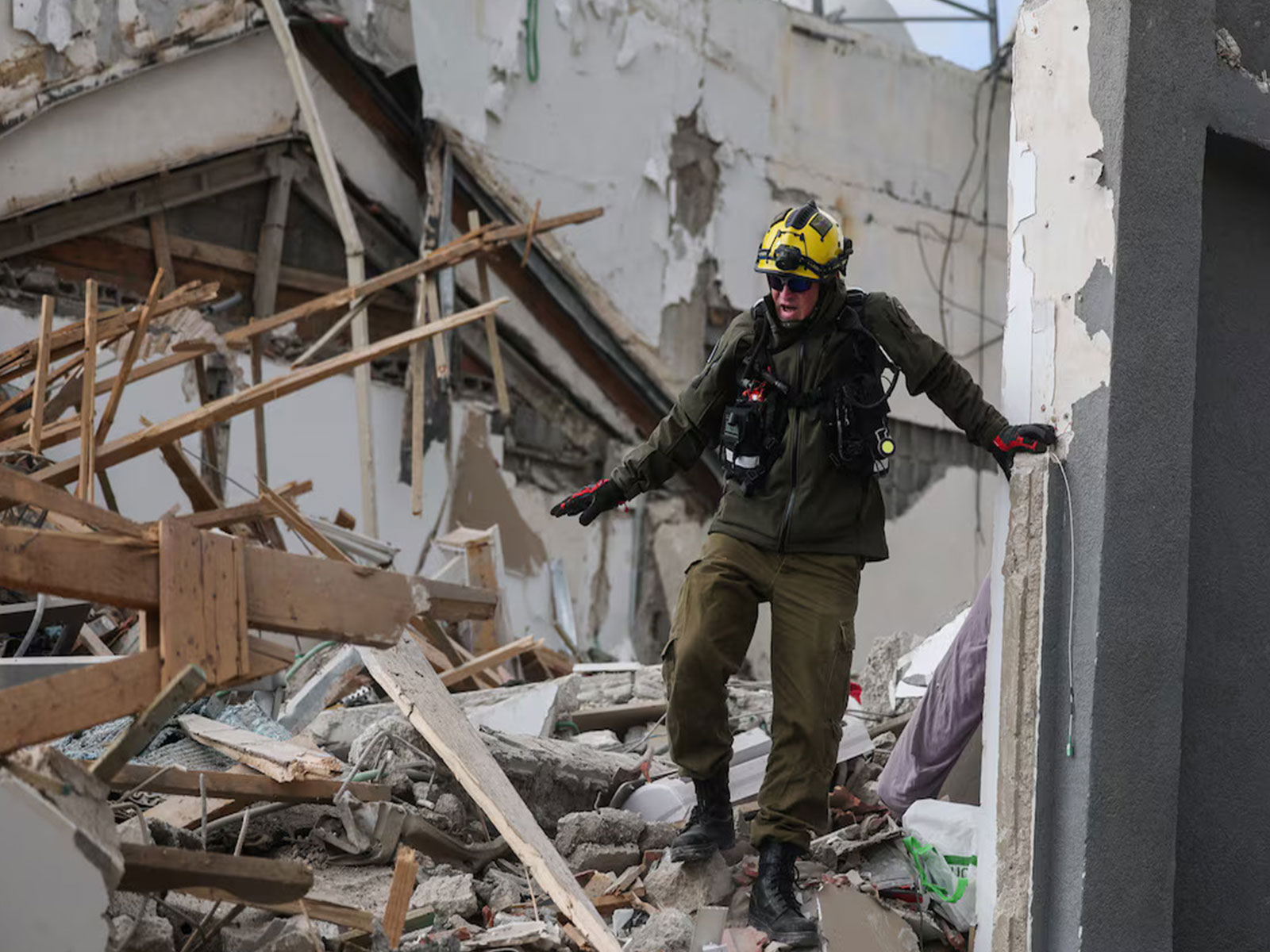 Emergency personnel conduct rescue and relief operations at the site of an Iranian missile strike. (Photo/Reuters)