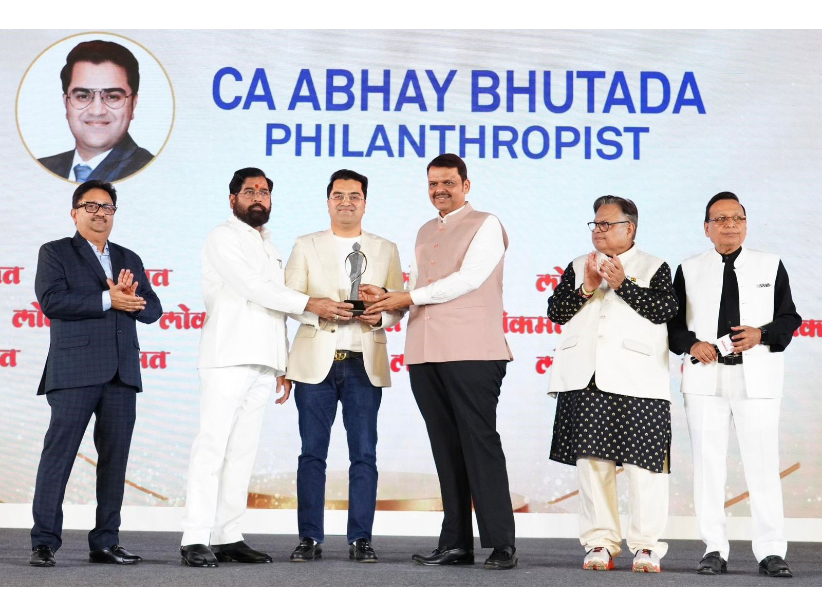 CA Abhay Bhutada receiving the Philanthropist of the Year Award 2026 from CM Shri Devendra Fadnavis and DCM Shri Eknath Shinde.