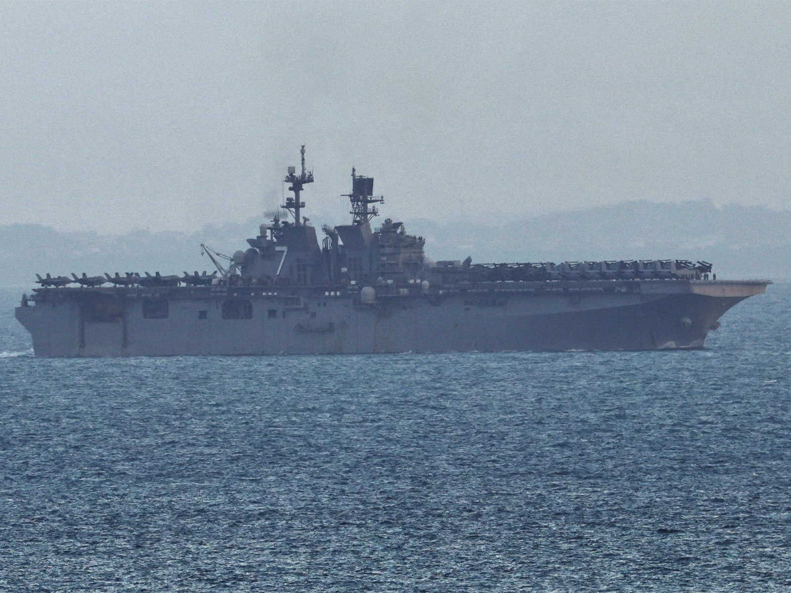 USS Tripoli enters the Singapore Straits, amid the US- Israeli conflict with Iran, as seen from Singapore (Photo/ Reuters)