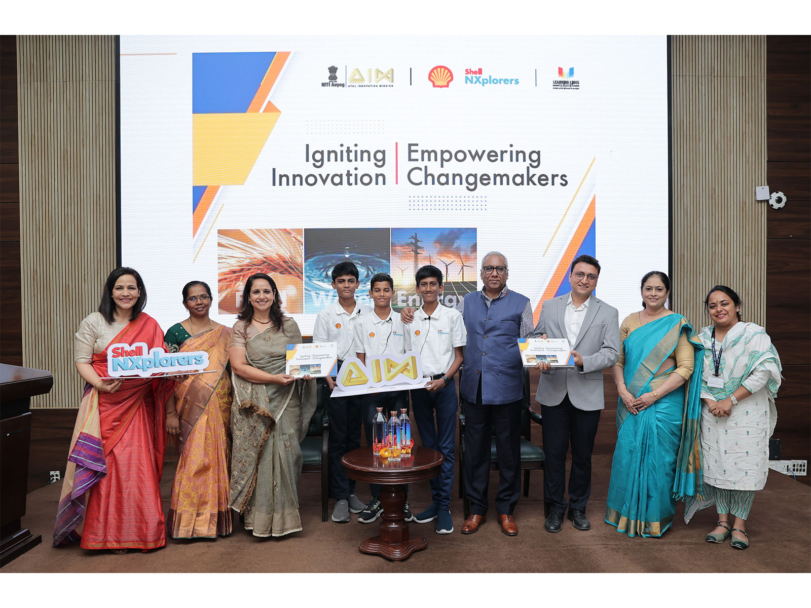 Officials from AIM, NITI Aayog, Shell India, and LLF, along with students and ATL Coordinator, at the unveiling of the NXplorers Coffee Table Book