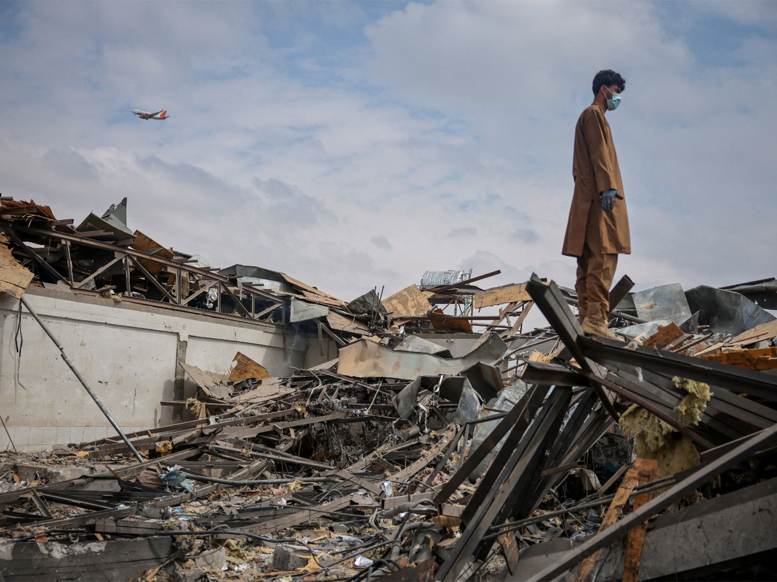 A man stands on the debris at the site of a drug rehabilitation hospital destroyed in Pakistani airstrike (Photo/Reuters)