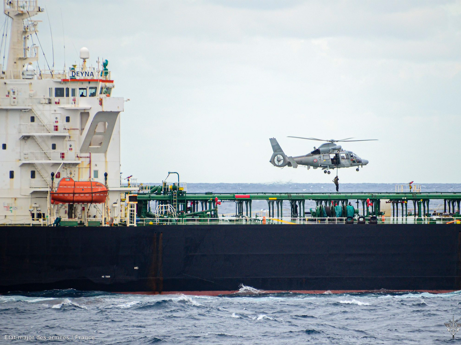 A French Navy helicopter hovers above the vessel Deyna during an interception operation targeting a suspected “ghost fleet” ship involved in sanctions evasion. (Photo: X/@EmmanuelMacron)